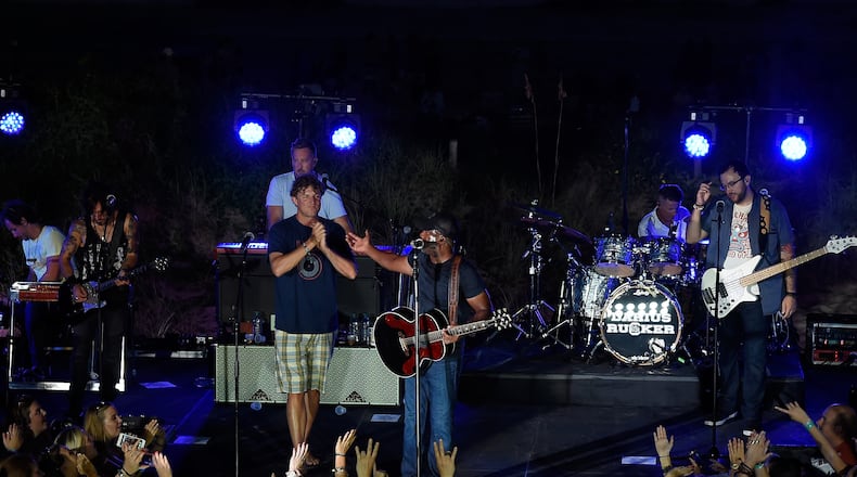 CHARLESTON, SC - AUGUST 26: Mark Bryan (L) of Hootie & the Blowfish joins the stage with Darius Rucker to perform a free, surprise pop-up concert in Charleston for CMT INSTANT JAM: DARIUS RUCKER at The Windjammer on August 26, 2015 in Charleston, South Carolina. The concert premieres September 5 at 10/9c on CMT. (Photo by Rick Diamond/Getty Images for CMT)