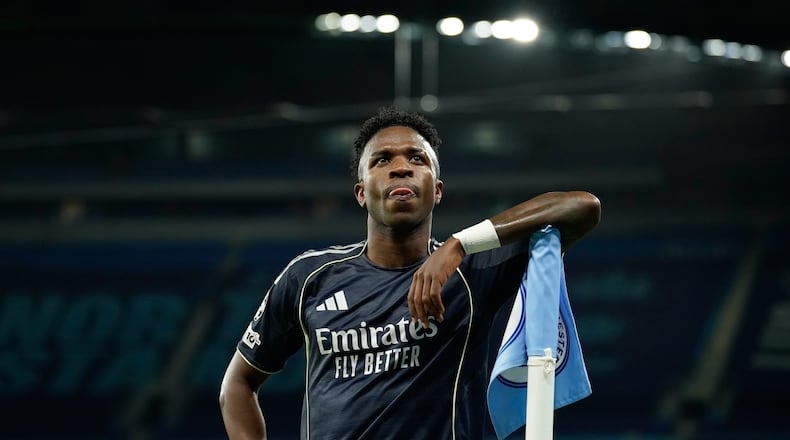 Real Madrid's scorer Vinicius Junior reacts at the corner flag after scoring the opening goal from the penalty spot during the Champions League round of 16 second leg soccer match between Manchester City and Real Madrid in Manchester, Tuesday, March 17, 2026. (AP Photo/Dave Thompson)