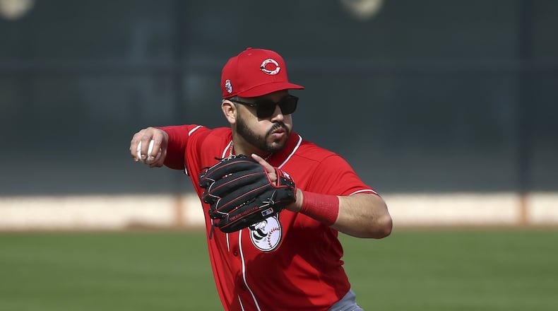 Cincinnati Reds third baseman Eugenio Suarez throws to first base during spring training baseball workouts Friday, Feb. 21, 2020, in Goodyear, Ariz. (AP Photo/Ross D. Franklin)