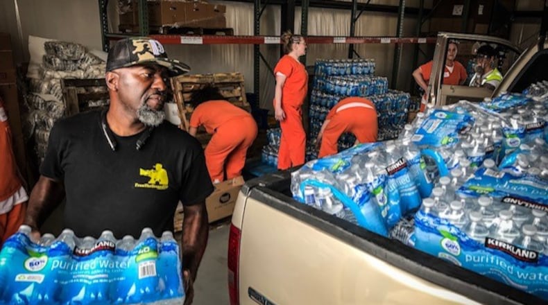 Bottled water is being distributed at The Foodbank in Dayton on Armor Place after the Memorial Day tornadoes. JIM NOELKER / STAFF