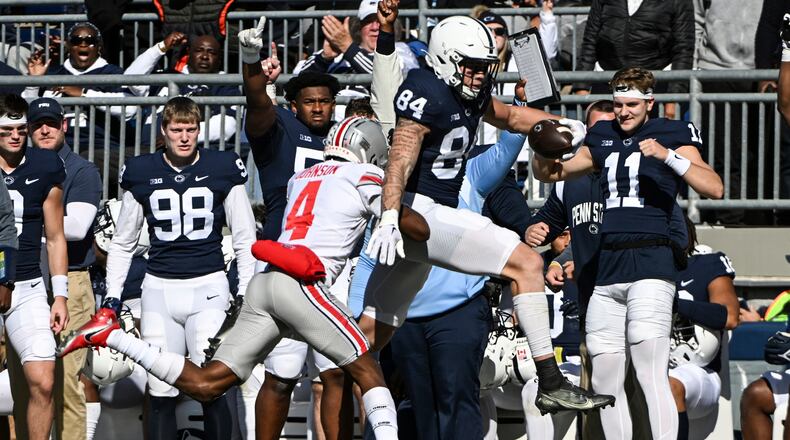 Penn State tight end Theo Johnson (84) gains yardage as Ohio State cornerback JK Johnson (4) chases him during the first half of an NCAA college football game, Saturday, Oct. 29, 2022, in State College, Pa. (AP Photo/Barry Reeger)
