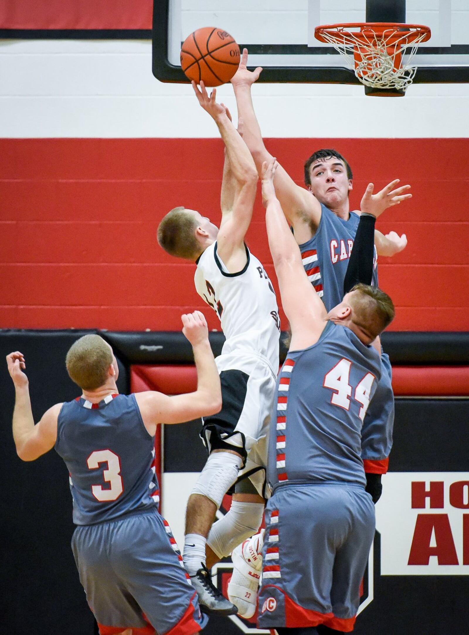 Preble Shawnee’s Kevin Ketring is surrounded by Carlisle’s Steve Summer (44), Jake Moore (3) and Justin Flor during Friday night’s game in Camden. NICK GRAHAM/STAFF