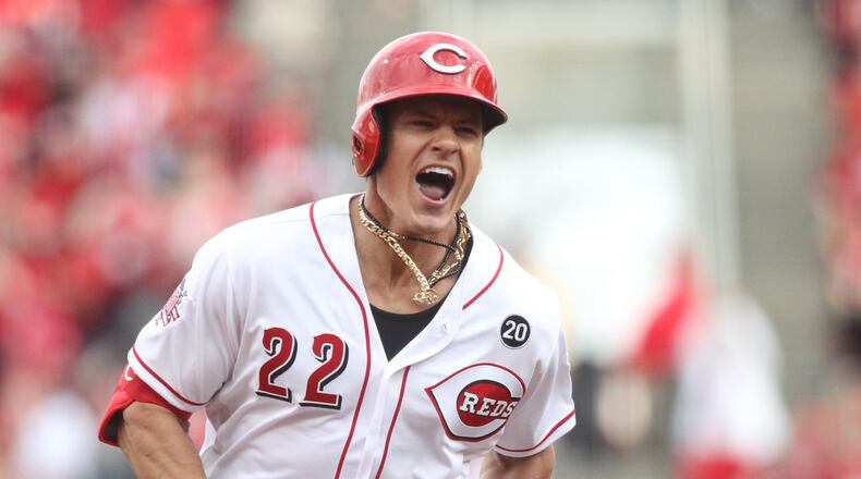 The Reds’ Derek Dietrich reacts after hitting a three-run, tie-breaking home run in the eighth inning against the Pittsburgh Pirates on Opening Day on Thursday, March 28, 2019, at Great American Ball Park in Cincinnati.