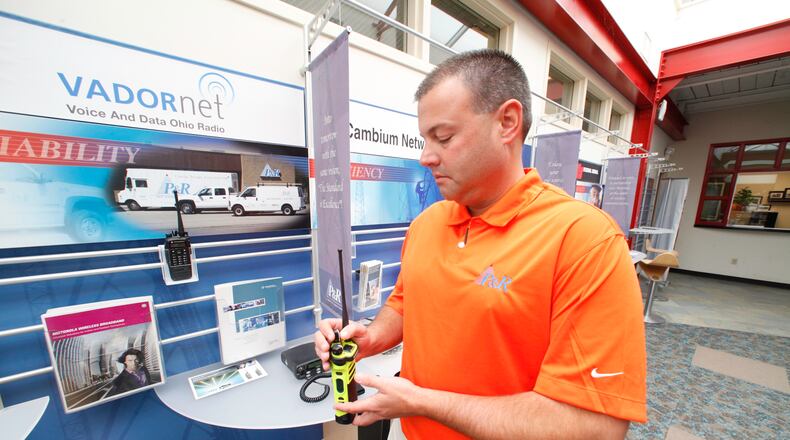 Chris Hanes, sales manager at P&R Communications Service, is seen with a new digital two-way radio used by the public safety sector. P&R representatives are in favor of the Marketplace Fairness Act that would require retailers to collect sales tax on online sales. CHRIS STEWART / STAFF