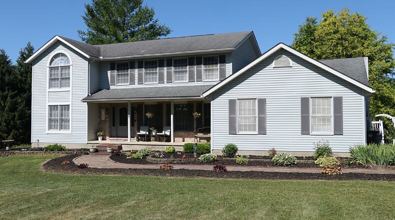 A covered porch stretches across the front as a paver-brick walkway leads to the formal entry of the 4- or 5-bedroom home. The 2-story offers about 2,630 sq. ft. of living space with an unfinished basement. CONTRIBUTED PHOTO BY KATHY TYLER