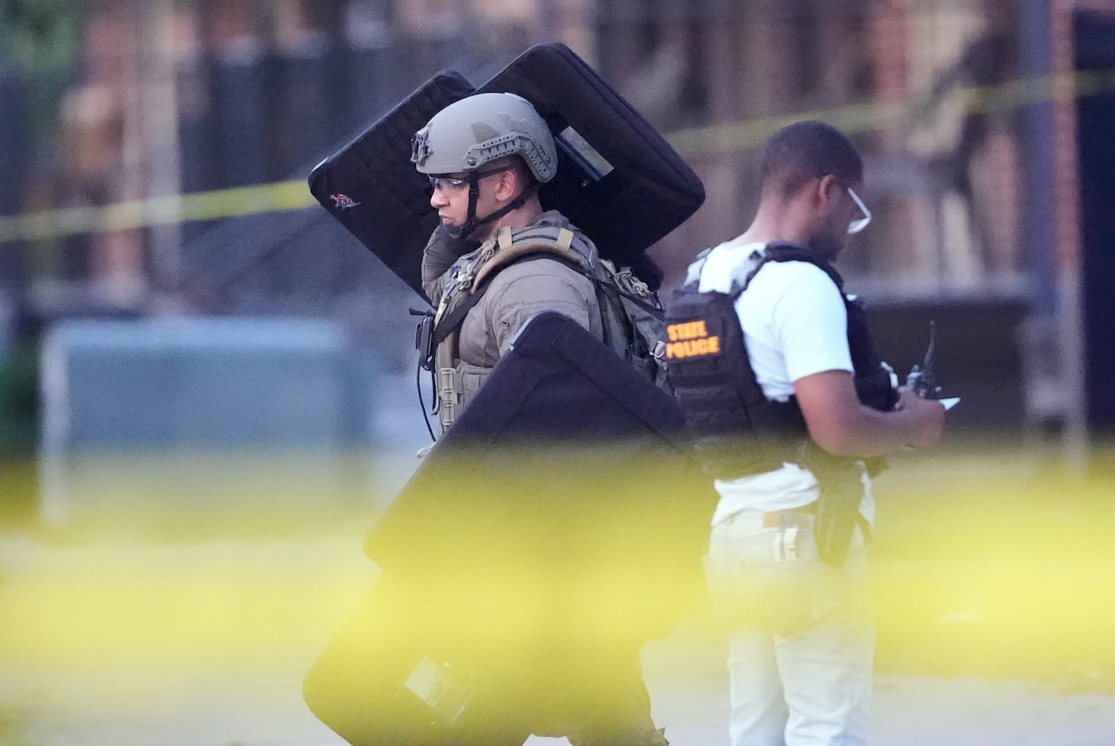 Louisiana law enforcement work the scene on Iberville Street as they pursue a fugitive that escaped from a New Orleans jail, Tuesday, May 20, 2025, in New Orleans. (AP Photo/Gerald Herbert)