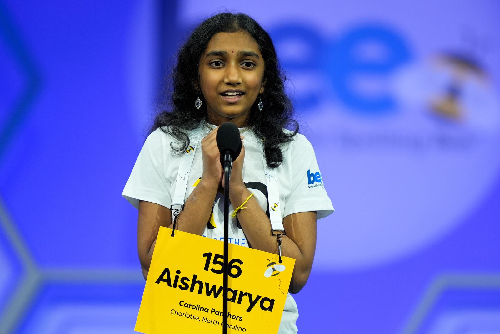 Aishwarya Kallakuri, 14, of Charlotte, N.C., reacts after spelling a word correctly in the semifinals of the Scripps National Spelling Bee, Wednesday, May 28, 2025, in Oxon Hill, Md. (AP Photo/Julia Demaree Nikhinson)
