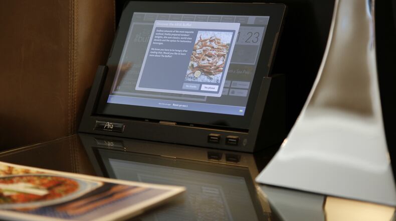 This April 21, 2017, photo, shows an interactive tablet in a suite at the Aria hotel in Las Vegas. The tablet allows guests to schedule breakfast delivery, access thousands of publications and adjust temperature and lights, among other things. (AP Photo/John Locher)