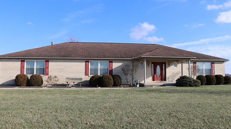 The 3-bedroom brick ranch, which offers about 2,350 sq. ft. of living space, sits on a 2.3-acre lawn, surrounded by an additional 34.84 acres available for purchase. The home has a side-entry, 3-car garage. CONTRIBUTED PHOTO BY KATHY TYLER