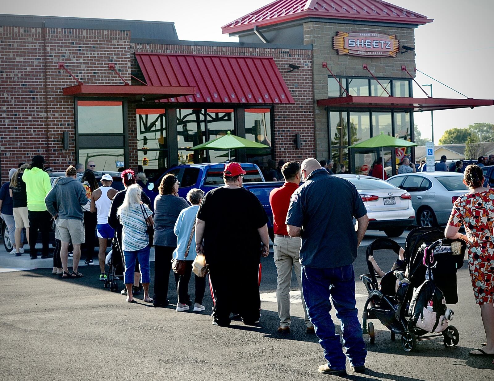 Nearly 100 people wait in line to register for prizes at the grand opening of the new Sheetz in Huber Heights Tuesday, Aug. 29, 2023. MARSHALL GORBY \STAFF