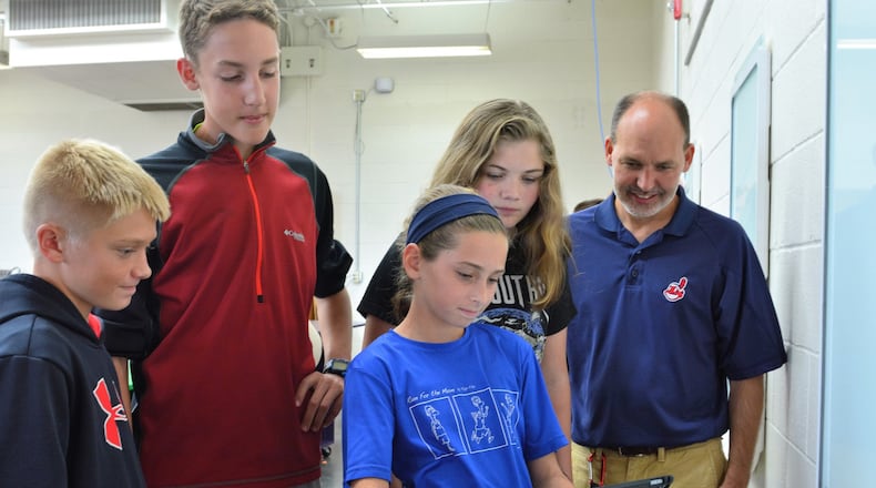 Students in the Tipp City Design Thinking class prepare to write their ideas to the latest class challenge on a smart board. Pictured (from left): students Peyton Taylor, Ben Prenger, Ava Newbourn and teacher Dale Bonifas. In front is Mia Larned. CONTRIBUTED