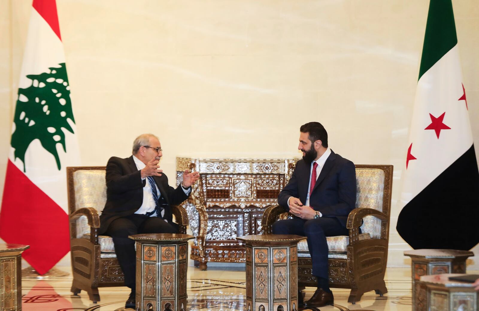 In this photo released by the Lebanese Government press office, Lebanese Prime Minister Nawaf Salam, left, meets with Syria's interim President Ahmad al-Sharaa in Damascus, Syria, Monday, April 14, 2025. (Lebanese Government press office via AP)