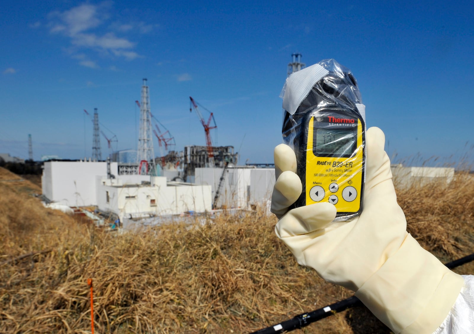 FILE -A radiation monitor indicates 131.00 mSv per hour near Unit 3 and 4 reactor buildings at Tokyo Electric Power Co.,'s tsunami-crippled Fukushima Dai-ichi nuclear power station in Okuma, Fukushima prefecture, northeastern Japan, Tuesday, Feb. 28, 2012. (AP Photo/Kimimasa Mayama, Pool, File)