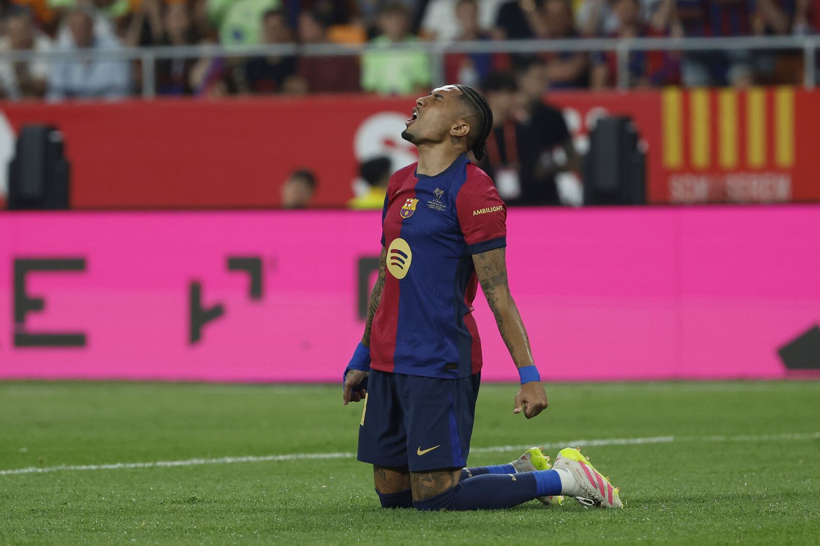 Barcelona's Raphinha reacts after a missed scoring opportunity during the Spanish Copa del Rey final soccer match between Barcelona and Real Madrid at Estadio de La Cartuja stadium in Seville, Spain, Saturday, April 26, 2025. (AP Photo/Joan Monfort)