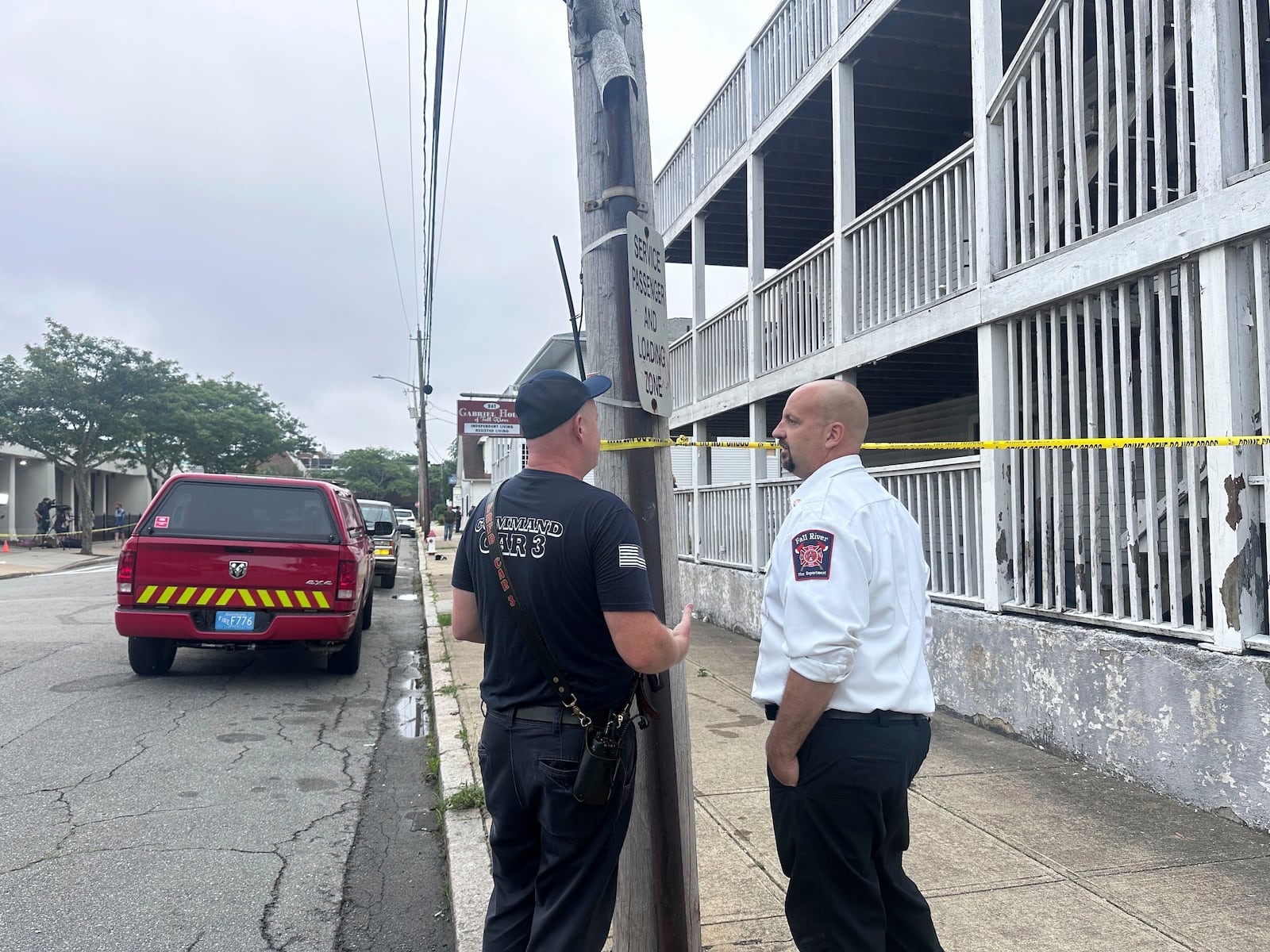 Falls River Fire Chief Jeffrey Bacon, right, speaks with another official after a fire the Gabriel House assisted living facility in Falls River, Mass., Monday, July 14, 2025. (AP Photo/Michael Casey)