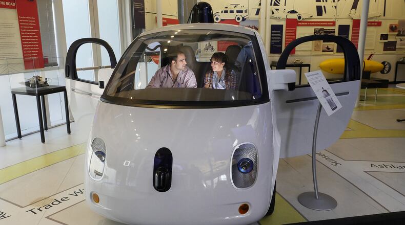Julio Alvarez, at left, and Sandra Galvez, visiting from Miami, Florida, sit in a self-driving Google car at the Computer History Museum Thursday, March 30, 2017, in Mountain View, Calif. (Jim Gensheimer/Bay Area News Group/TNS)