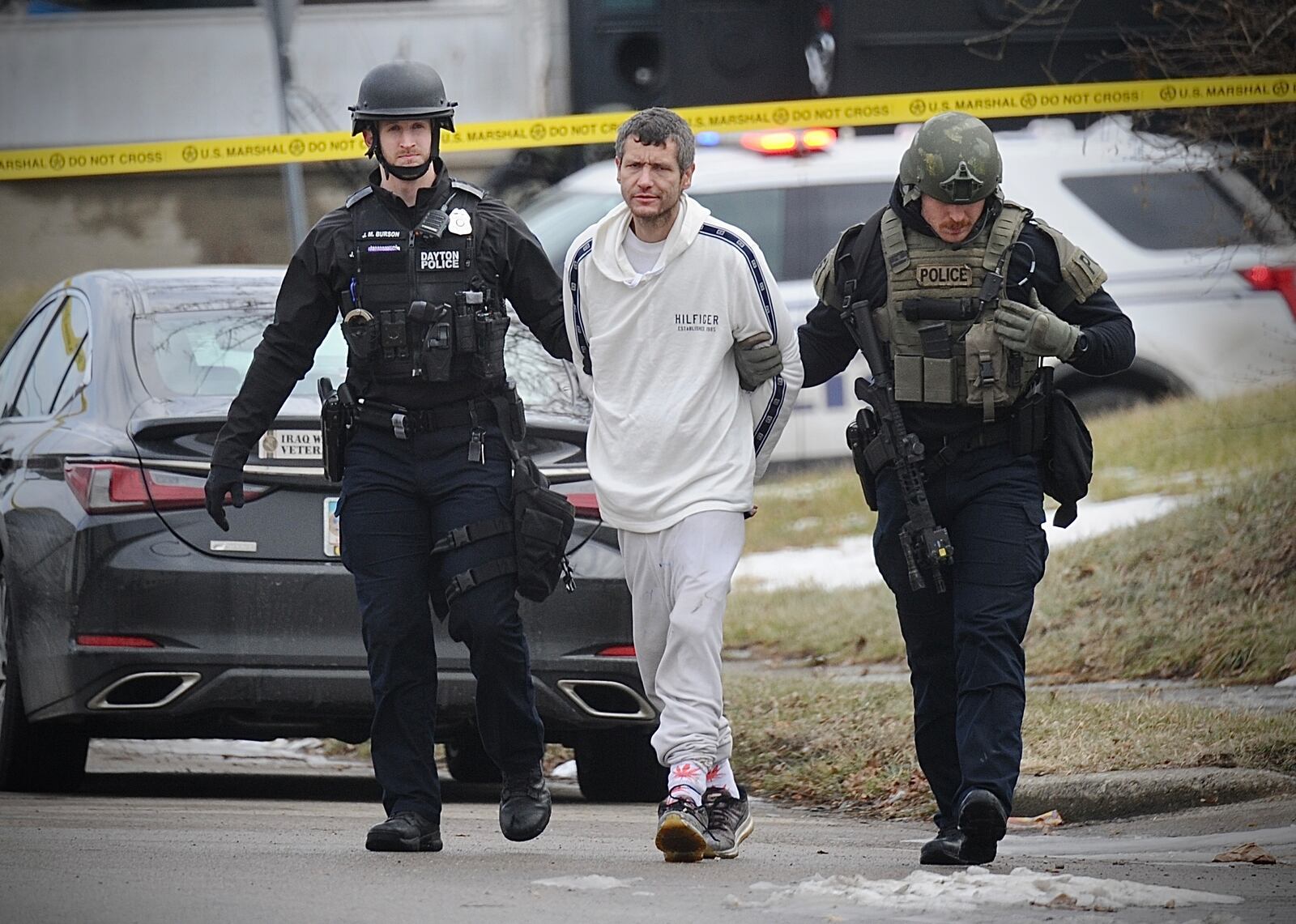 Dayton SWAT team members escort Charles Vititoe Jr. following a nearly five-hour standoff Thursday, Dec. 29, 2022, when law enforcement attempted to arrest him on a warrant. MARSHALL GORBY/STAFF
