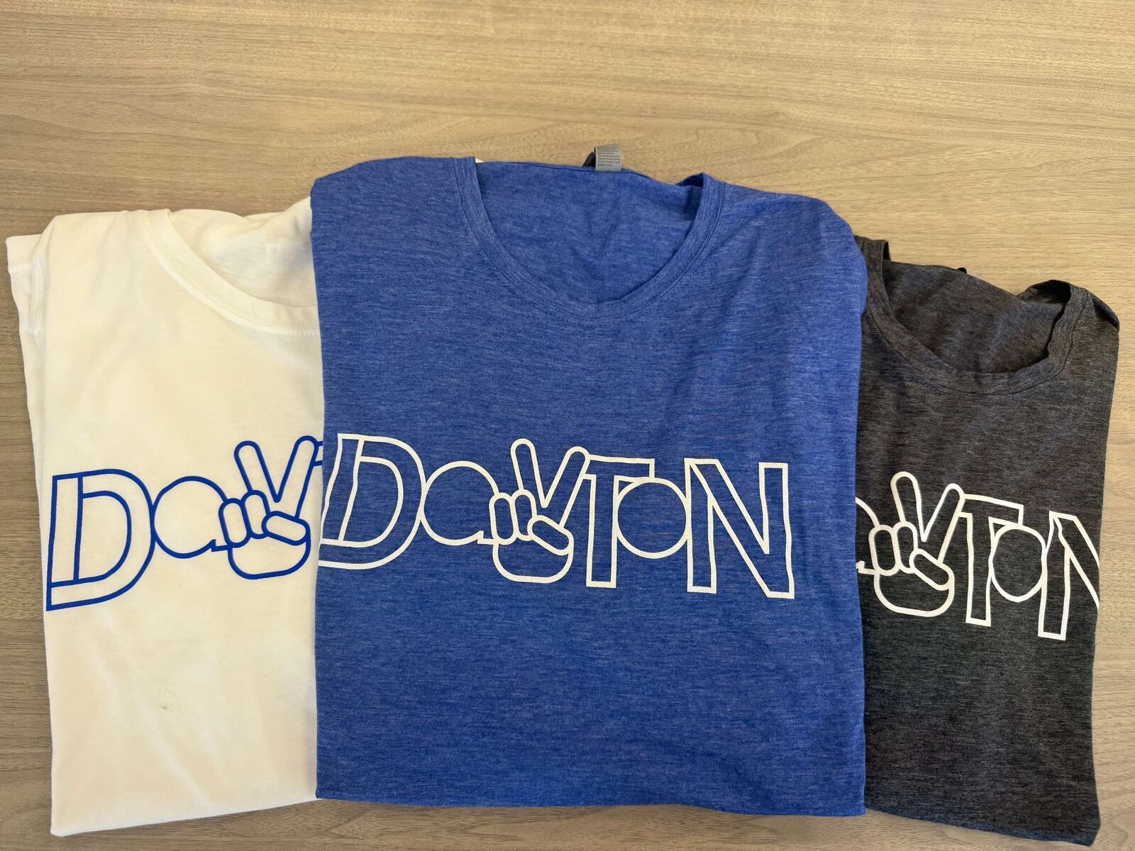 Just in time for the NATO Parliamentary Assembly, the Downtown Dayton Partnership is debuting t-shirts highlighting Dayton’s newest landmark. The shirts (available in royal blue, charcoal or white) feature the design of the new Dayton Peace Sign, currently located at RiverScape MetroPark (FACEBOOK PHOTO).