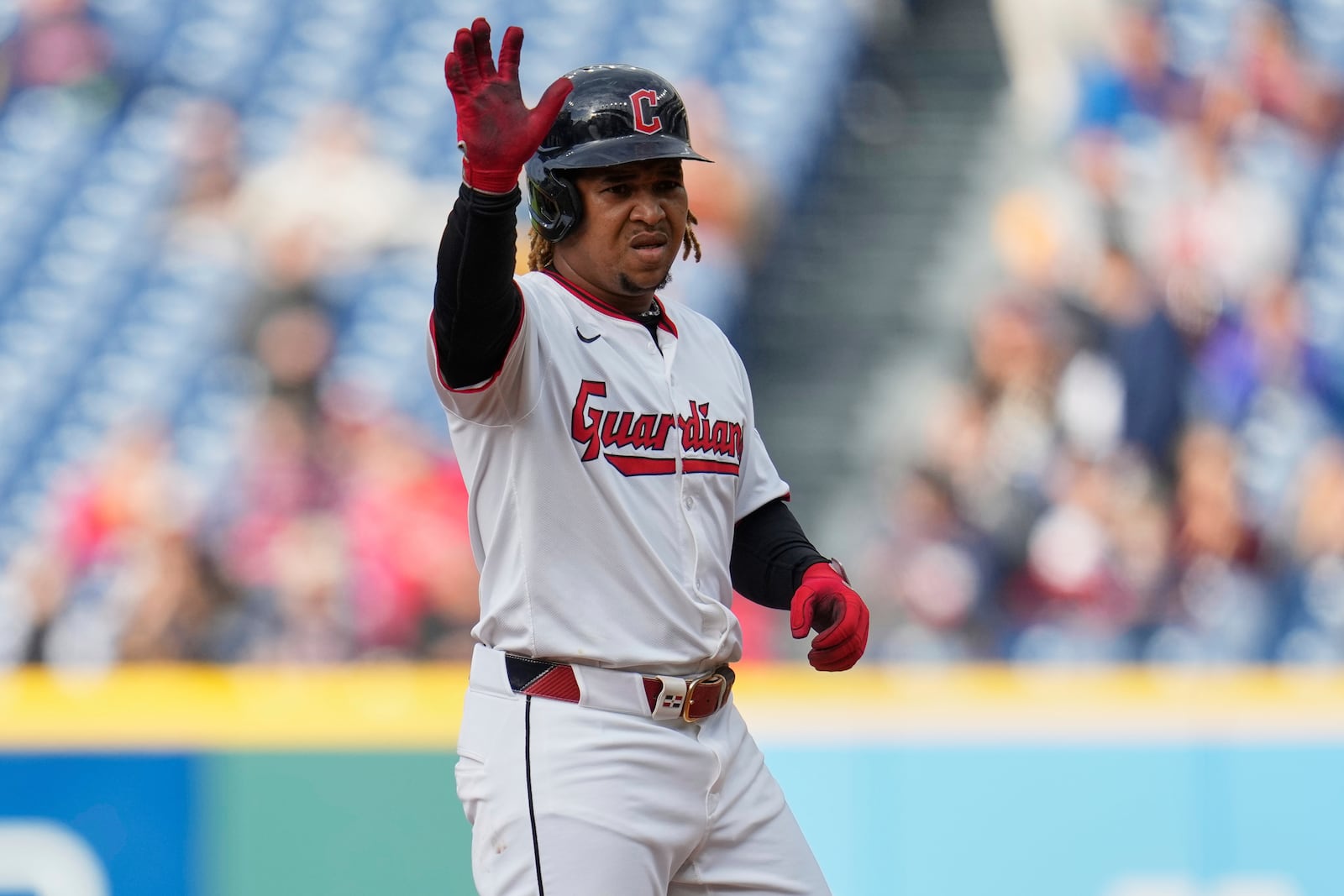 Cleveland Guardians' Jose Ramirez gestures from second base after hitting a double in the first inning of a baseball game against the Minnesota Twins in Cleveland, Wednesday, April 30, 2025. (AP Photo/Sue Ogrocki)