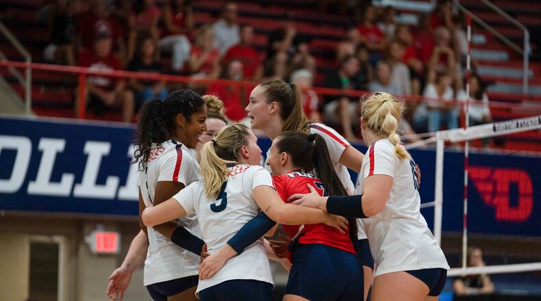 The Dayton volleyball team huddles during a preseason match in August 2021. Photo by AJ Schrafenberger, Dayton Athletics Communication