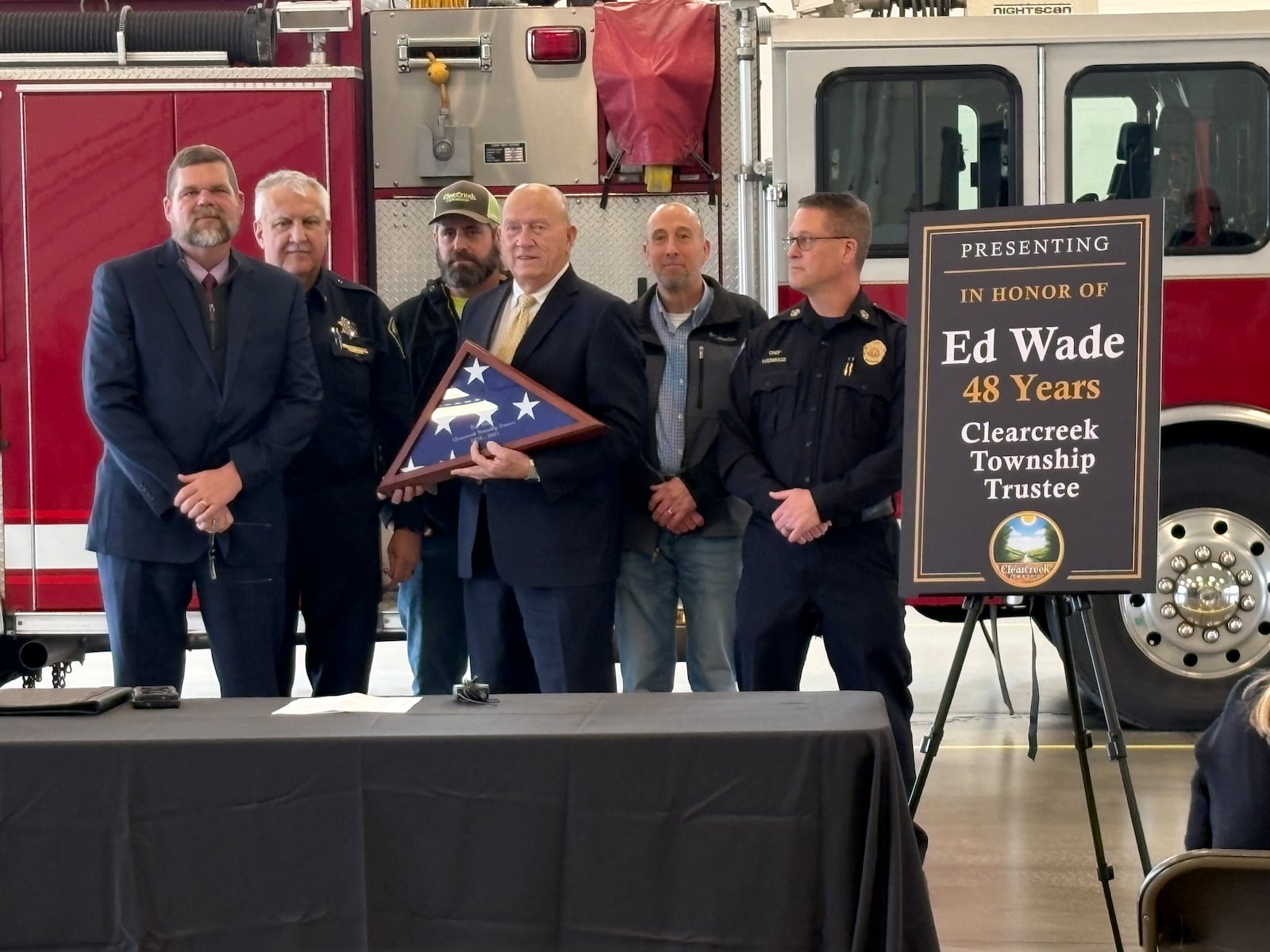 Clearcreek Twp. Trustee Ed Wade, center, was presented with an American flag that flew over the Ohio Statehouse in honor of his 48 years of public office during an event Monday, Dec. 22, 2025, at the Clearcreek Fire District headquarters. JEN BALDUF/STAFF