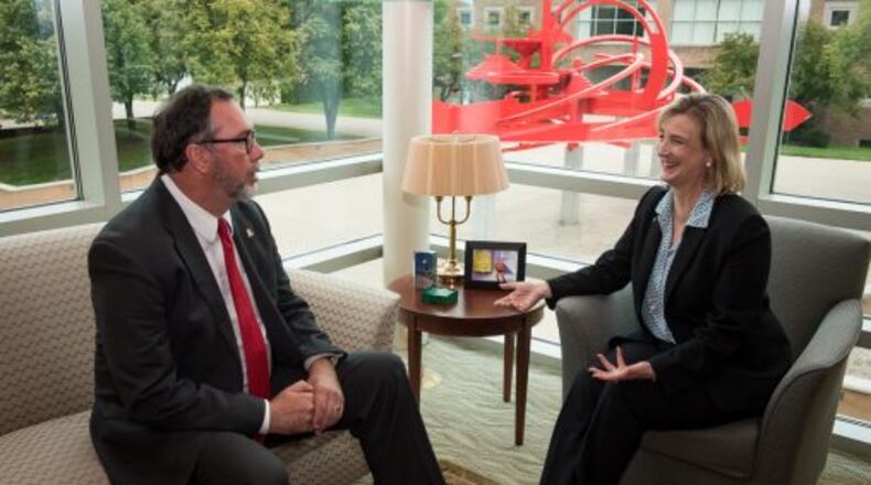 WSU’s Cheryl Schrader meets in her office with Sinclair Community College president Steve Johnson.