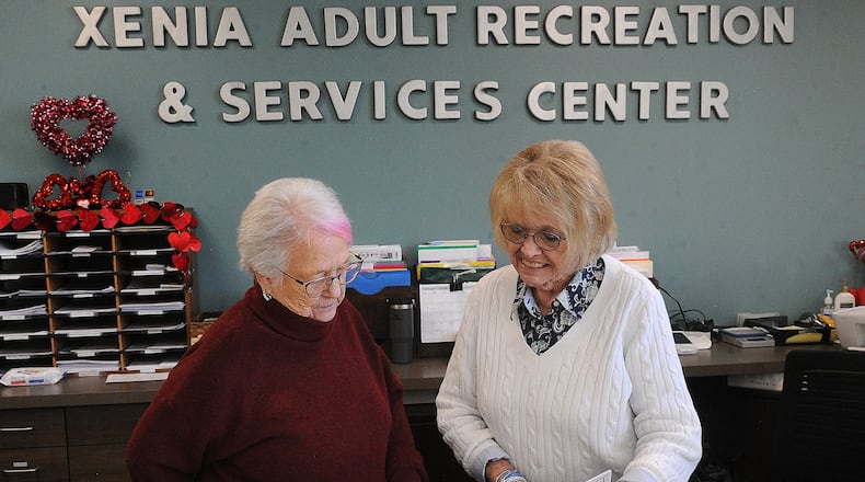 Linda Williamson, Program Manager, left, and Caroyn Pitstick, Secretary for the Xenia Adult Recreation & Services Center look over this months upcoming events. MARSHALL GORBY\STAFF