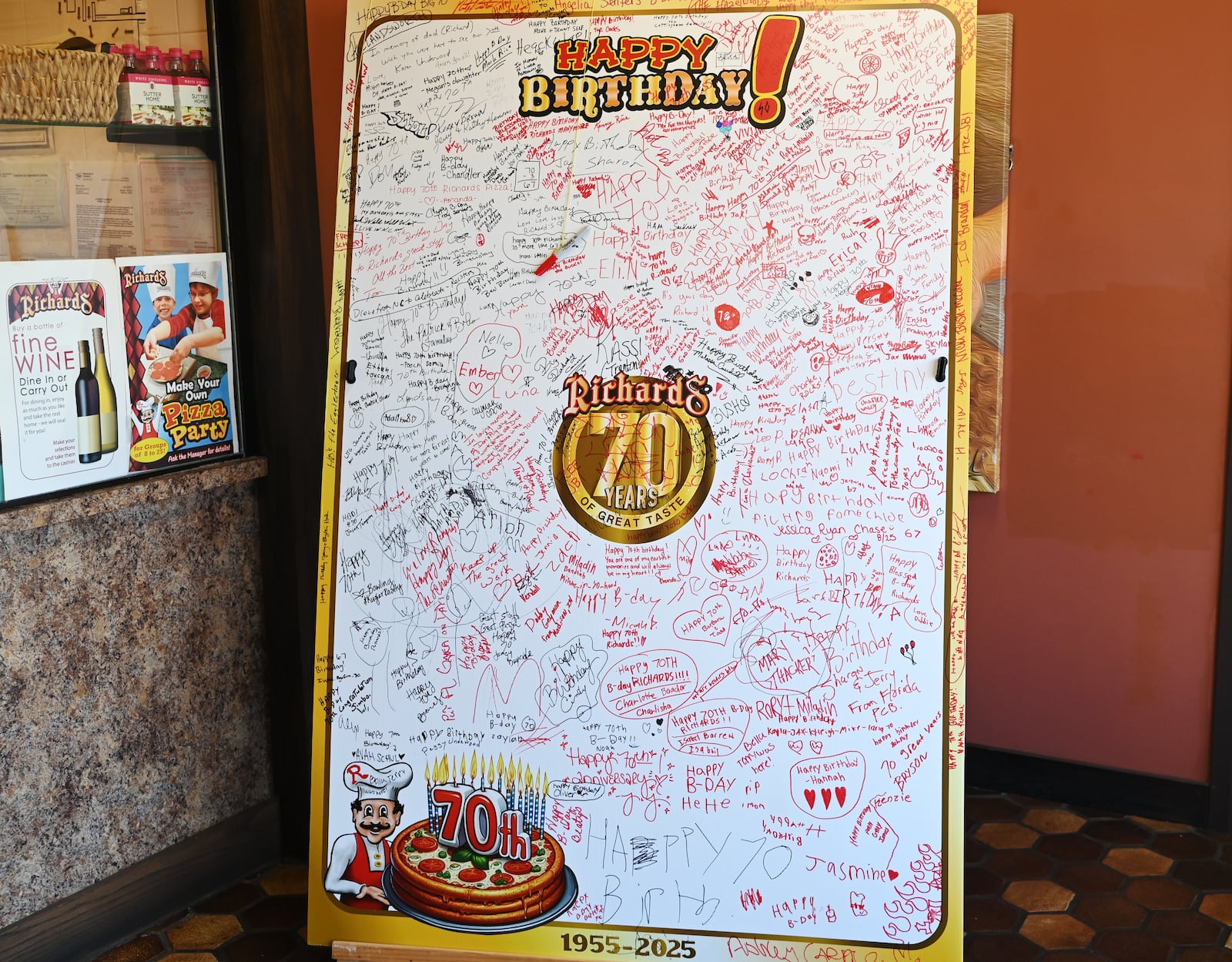 Richards Pizza celebrates 70 years of business in Butler County. Founded in Hamilton by Richard Underwood in 1955, the beloved local chain with four locations will celebrate its anniversary with 50-cent steak sandwiches, the price when it was created in 1956. Pictured is the oversized anniversary card guests have signed when they visit the Hamilton location on Main Street. MICHAEL D. PITMAN/STAFF