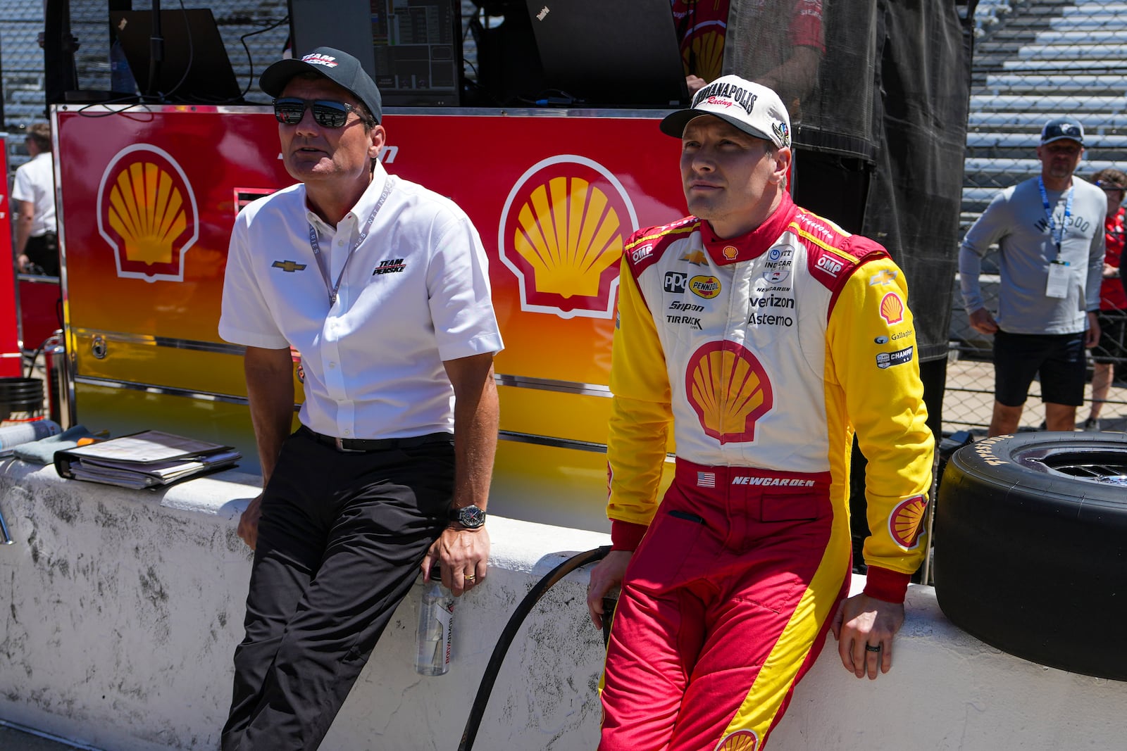 President of Team Penske Tim Cindric, left and driver Josef Newgarden wait for the start of during practice for the Indianapolis 500 auto race at Indianapolis Motor Speedway in Indianapolis, Sunday, May 18, 2025. (AP Photo/Michael Conroy)
