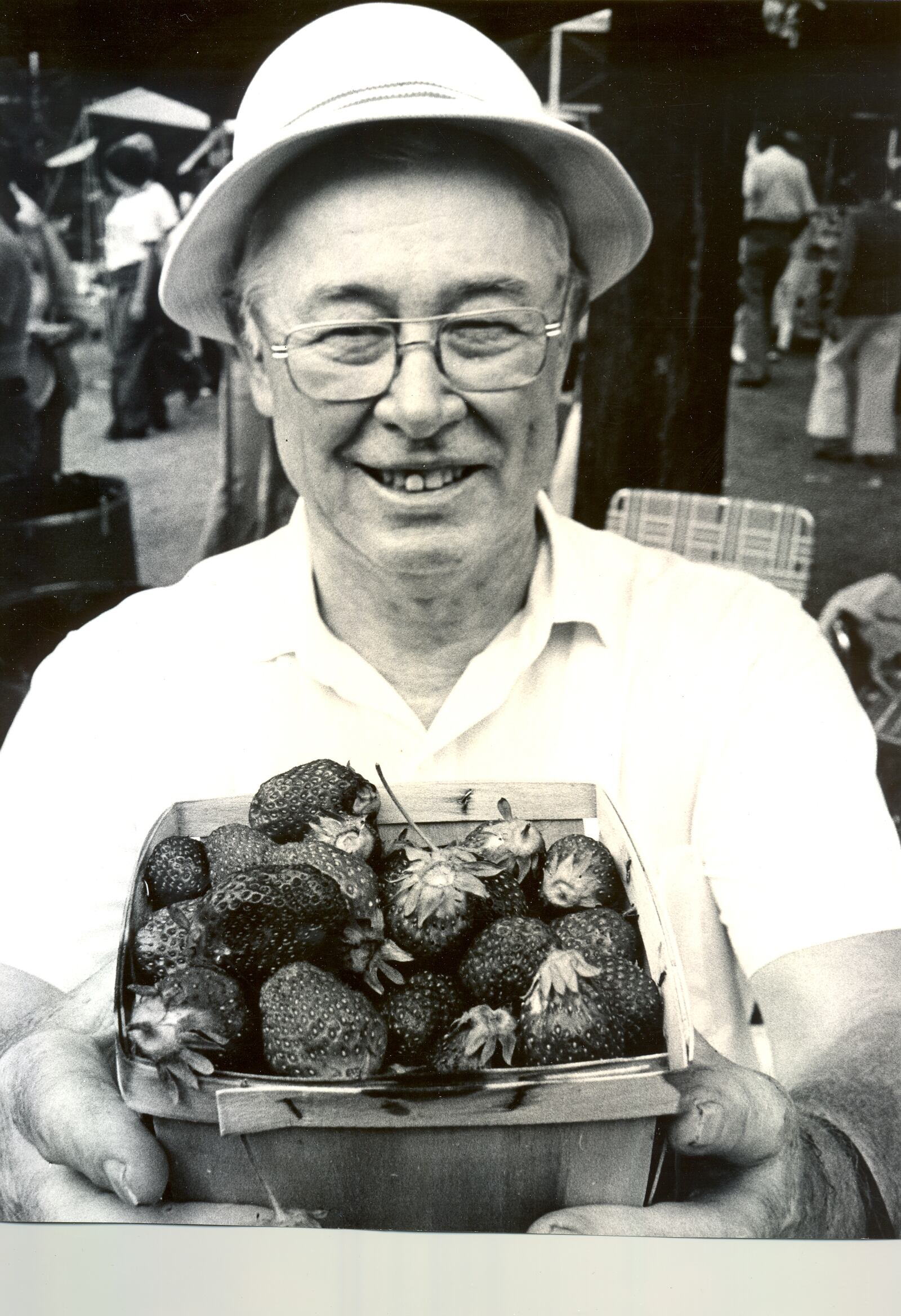 Bill McGarry, of Syracuse, NY., holds a quart basket of "Troy's finest". The berries were sold in shortcake, sundaes, beverages and just plain at Troy's First Strawberry Festival along the banks of the Miami River. June 13, 1977. Archive photo by Mark Duncan.