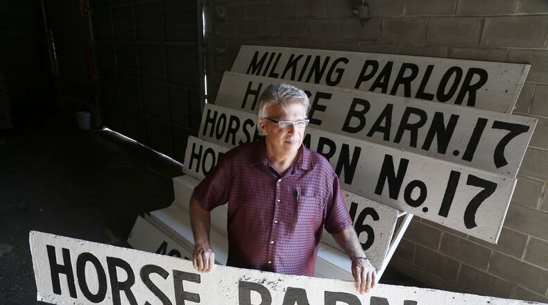 Greg Wallace, executive director for the Montgomery County Agricultural Society, holds one of the signs that designated the horse barns at the Montgomery County Fairgrounds. The signs, along with other nostalgic items, and a variety of office chairs, a fork lift, a tractor and more will be auctioned off Tuesday, Sept. 26 at noon at the fairgrounds. LISA POWELL / STAFF
