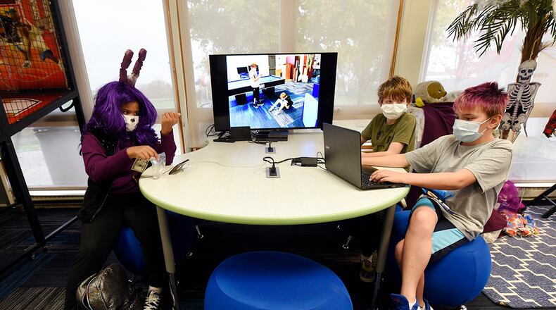 Club members (from the left) Chayna Griffith, Ian Hogge and Josh Hire spend their afternoon in the renovated Prairies Youth Center Oct. 29. U.S. AIR FORCE PHOTO/TY GREENLEES