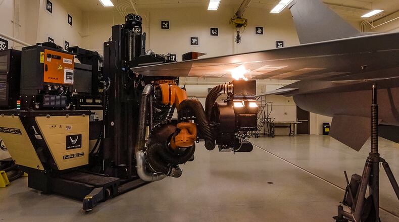 The newly approved Robotic Laser Coating Removal System vaporizes paint in a self-contained process that significantly reduces environmental hazards to maintainers. Air Force Research Laboratory contributed technical expertise to help enable the use of this technology for production F-16 aircraft. (Courtesy photo/ Dale Jackson, University of Dayton Research Institute)