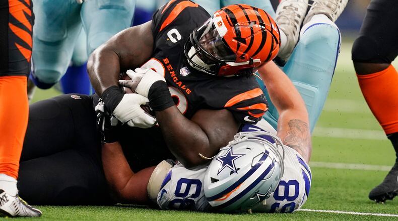 Cincinnati Bengals defensive tackle DJ Reader (98) protects the ball after a fumble recovery as Dallas Cowboys guard Matt Farniok (68) makes the stop during the second half of an NFL football game Sunday, Sept. 18, 2022, in Arlington, Tx. (AP Photo/Tony Gutierrez)