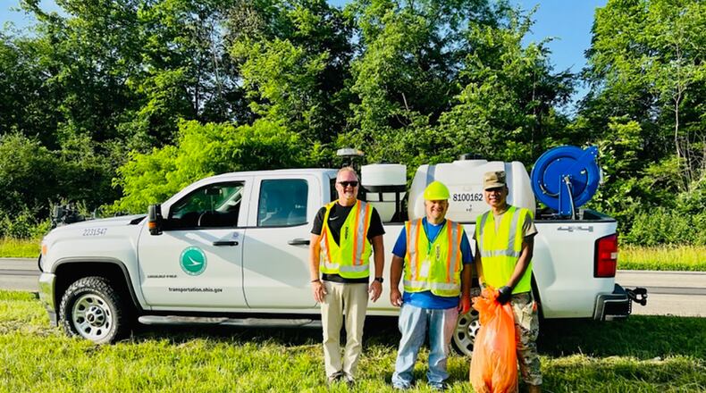 Ohio Department of Transportation representatives Guy Baker (left) and Micah Brashear (center) stand for a photo June 16 with Tech. Sgt. Randolph Koram, National Air and Space Intelligence Center volunteer coordinator, while picking up litter on the roads outside Wright-Patterson Air Force Base as part of the state’s Adopt-A-Highway program. CONTRIBUTED PHOTO