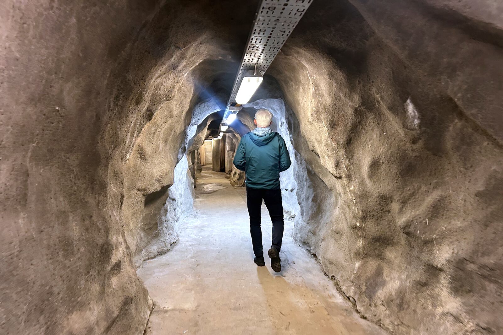 Odd John Resser, Emergency Planning Officer for the municipality, walks in the tunnel of a Cold War era underground shelter which was dusted off after Russia's invasion of Ukraine, in Kongsberg, Norway Thursday, May 8, 2025. (AP Photo/Emma Burrows)