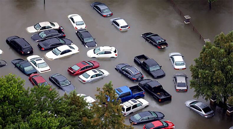 This Aug. 29 photo shows flooded cars near the Addicks Reservoir as floodwaters from Harvey rise in Houston. Auto industry experts estimate that 500,000 to 1 million cars, trucks and SUVs were damaged by floodwaters from Hurricane Harvey. Most will have so much water damage that they can t be fixed, and insurance companies will declare them total losses. Yet the damaged cars could be retitled and sold to unsuspecting buyers nationwide. Experts warn against buying the cars because damage could be hidden for years before causing problems. (AP Photo/David J. Phillip)