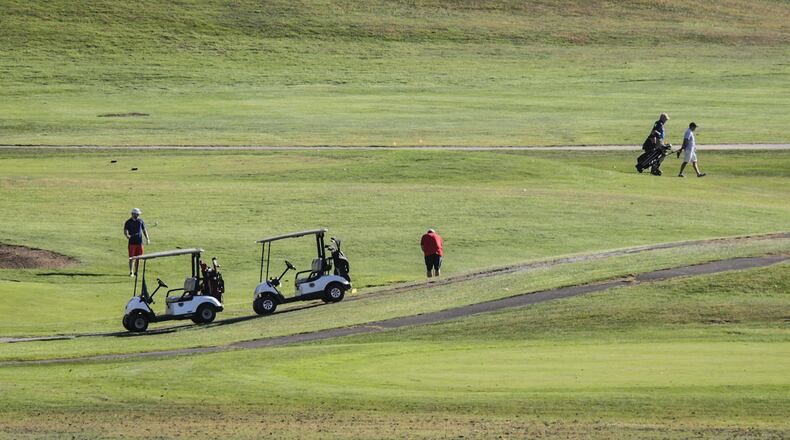 Golfers dotted the Community Golf Course in Kettering on a warm autumn afternoon. During COVID-19, many area golf courses stayed open but limited their services. JIM NOELKER/STAFF