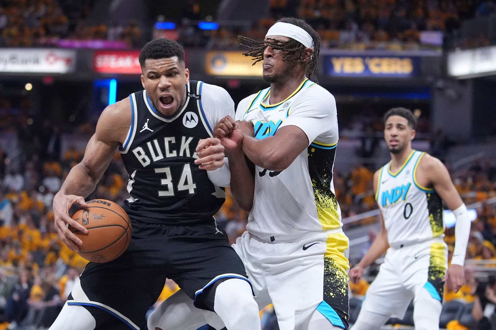 Milwaukee Bucks' Giannis Antetokounmpo (34) battles with Indiana Pacers' Myles Turner, right, during the second half of a first-round NBA basketball playoff game, Saturday, April 19, 2025, in Indianapolis. (AP Photo/Michael Conroy)
