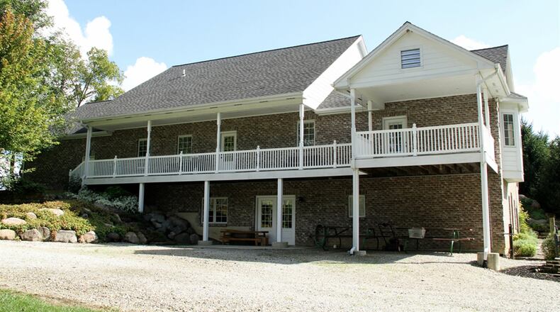 The main bedroom and breakfast room open out to the balcony deck that stretches across the back of the house. A recreation room with kitchenette opens to a concrete patio and back yard.