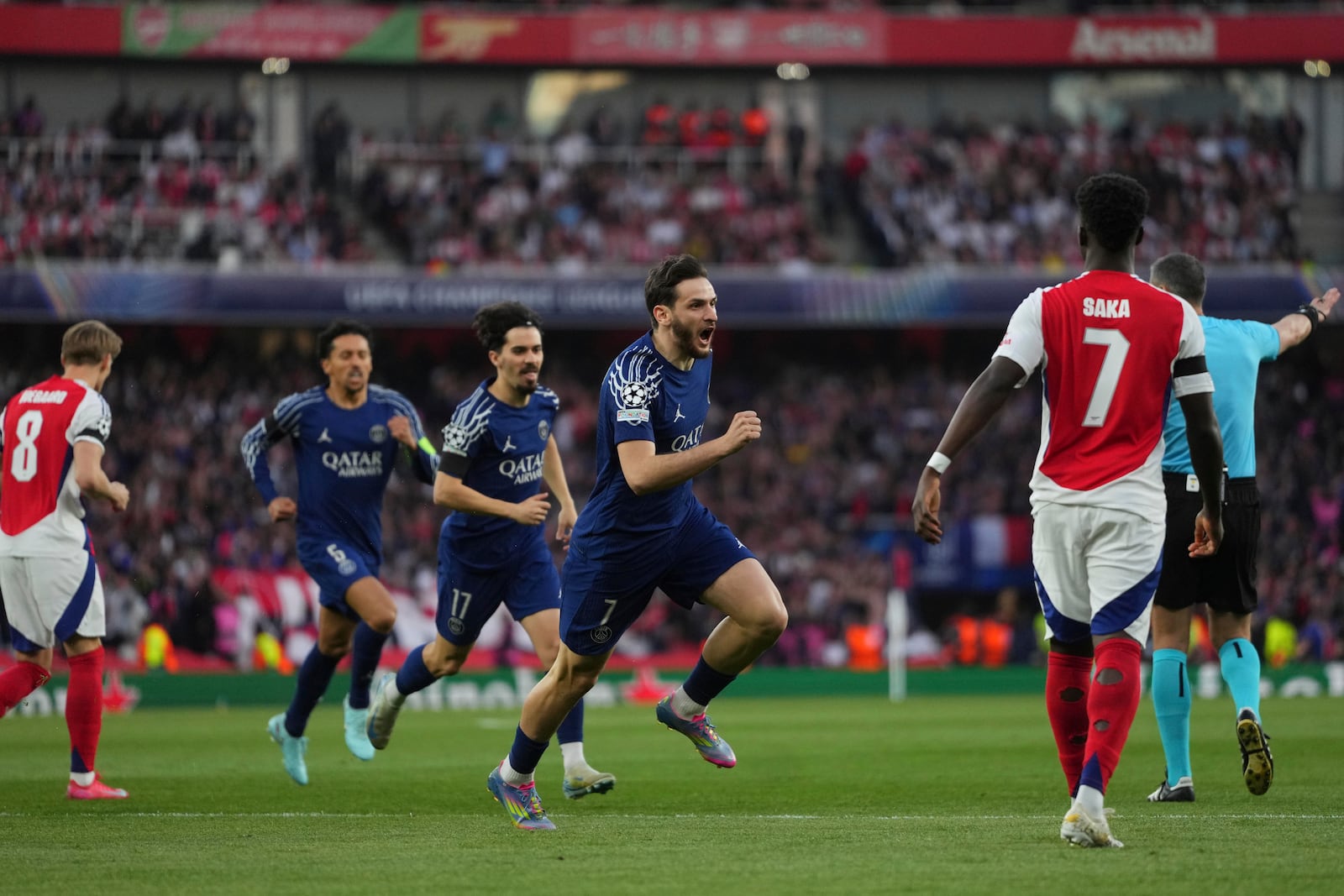PSG players celebrate after their teammate Ousmane Dembele scored his side's opening goal during the Champions League semifinal first leg soccer match between Arsenal and Paris Saint-Germain at Emirates Stadium in London, England, Tuesday, April 29, 2025. (AP Photo/Kirsty Wigglesworth)
