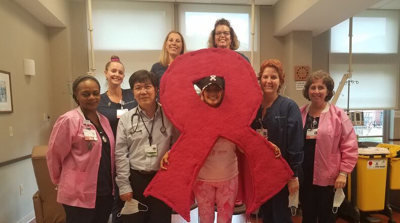 Julie Penrose of Springfield with the staff at the Mercy Health Springfield Cancer Center. Penrose wears a different superhero outfit to each cancer treatment session. CONTRIBUTED