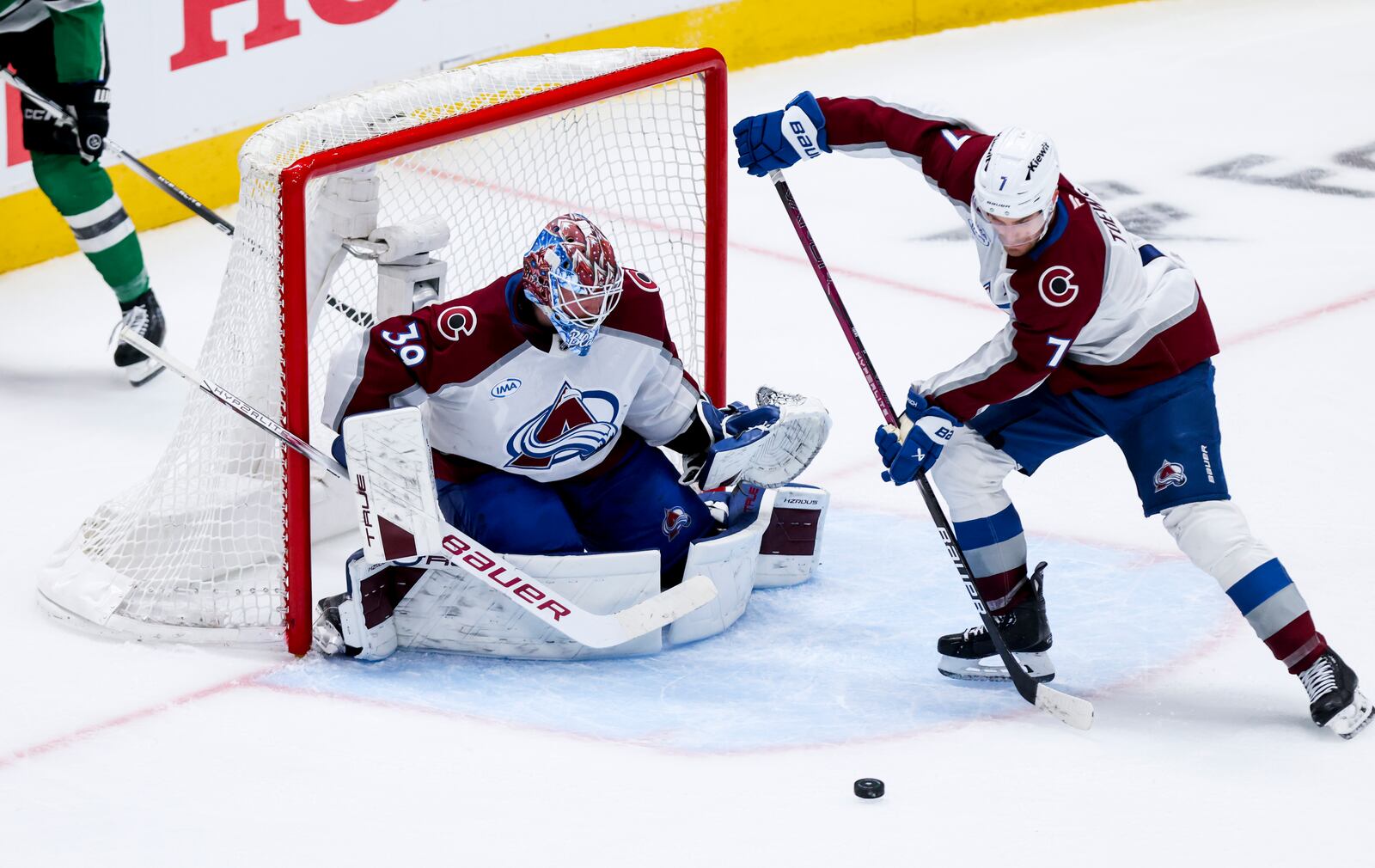 Colorado Avalanche defenseman Devon Toews (7) stops a shot in front of goaltender Mackenzie Blackwood (39) during a first-round NHL hockey playoff game against the Dallas Stars in Dallas, Saturday, April 19, 2025. (AP Photo/Gareth Patterson)