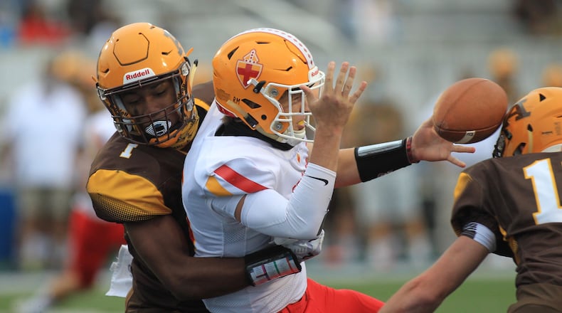 Alter's C.J. Hicks sacks Fenwick's Braden Listermann and forces a fumble that is recovered for a touchdown on Friday, Sept. 11, 2020, at Roush Stadium in Kettering. David Jablonski/Staff