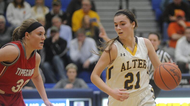 Alter’s Libby Bazelak (with ball) and Tipp’s Allison Mader. Alter defeated Tippecanoe 50-41 in a girls high school basketball D-II regional semifinal at Springfield High School on Tuesday, March 7, 2017. MARC PENDLETON / STAFF