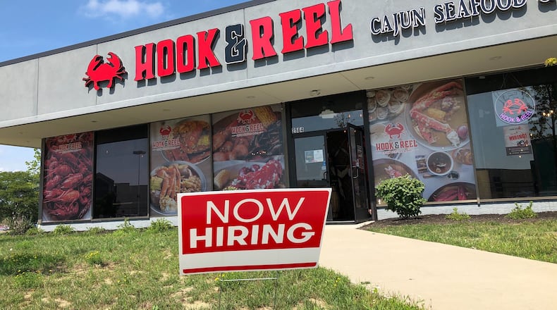 A new seafood restaurant, Hook & Reel Cajun Seafood & Bar, opens today, Aug. 18, 2020, in the building that formerly housed a Sears Tire & Auto center at the Dayton Mall. Hook & Reel shares the building with Outback Steakhouse, which opened last year. MARK FISHER/STAFF