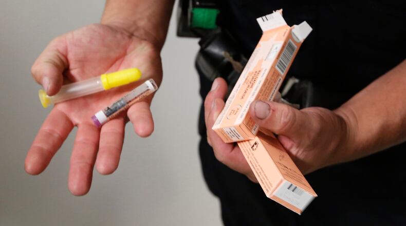 During a shift last year, Dayton Police Officer Joe Sheen replenished his supply of Narcan. CHRIS STEWART / STAFF