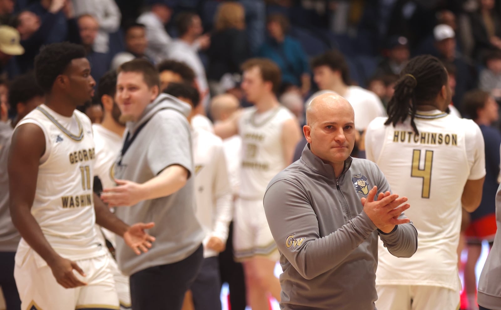 George Washington's Chris Caputo claps after a victory against Dayton on Saturday, Jan. 4, 2025, at the Charles E. Smith Center in Washington, D.C. David Jablonski/Staff