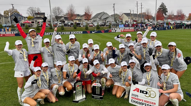 The Dayton women's soccer team poses for a photo after winning the Atlantic 10 Conference tournament by beating Rhode Island on Sunday, Nov. 9, 2025, at Baujan Field. David Jablonski/Staff