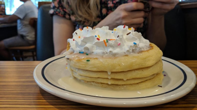 We tried out IHOP's structurally unsound cupcake pancakes, which are filled with rainbow sprinkles and topped with frosting, whipped cream, and more rainbow sprinkles. (Crystal Paul/The Seattle Times/TNS)